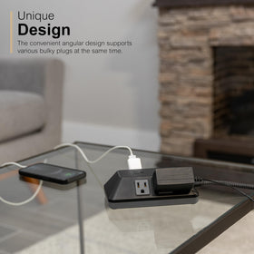 GE surge protector powering laptop and lamp at a desk for organized workspace