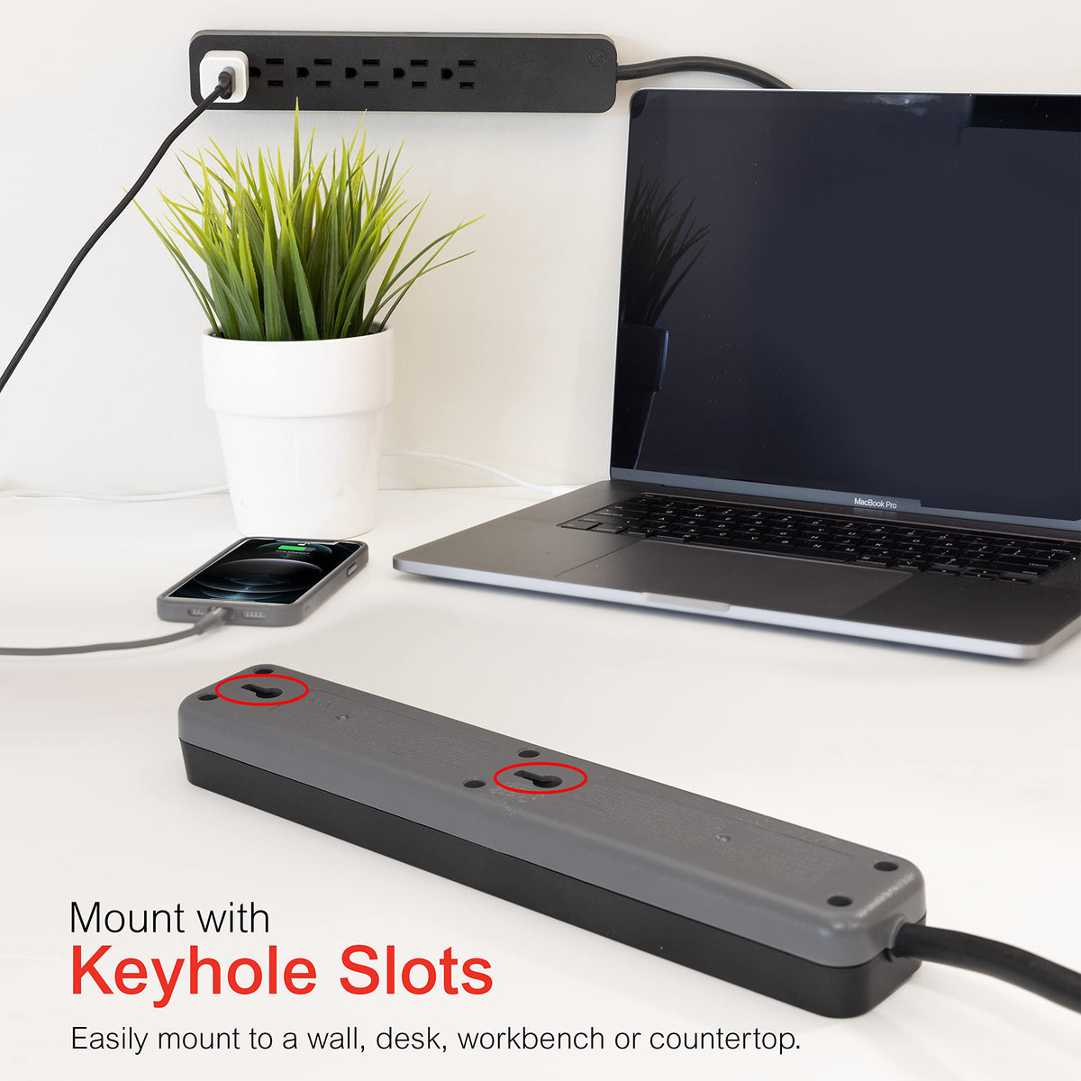 GE surge protector with wall-mount slots for desk or shelf use.