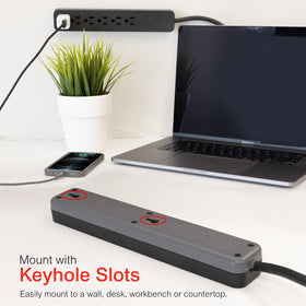 GE surge protector with wall-mount slots for desk or shelf use.