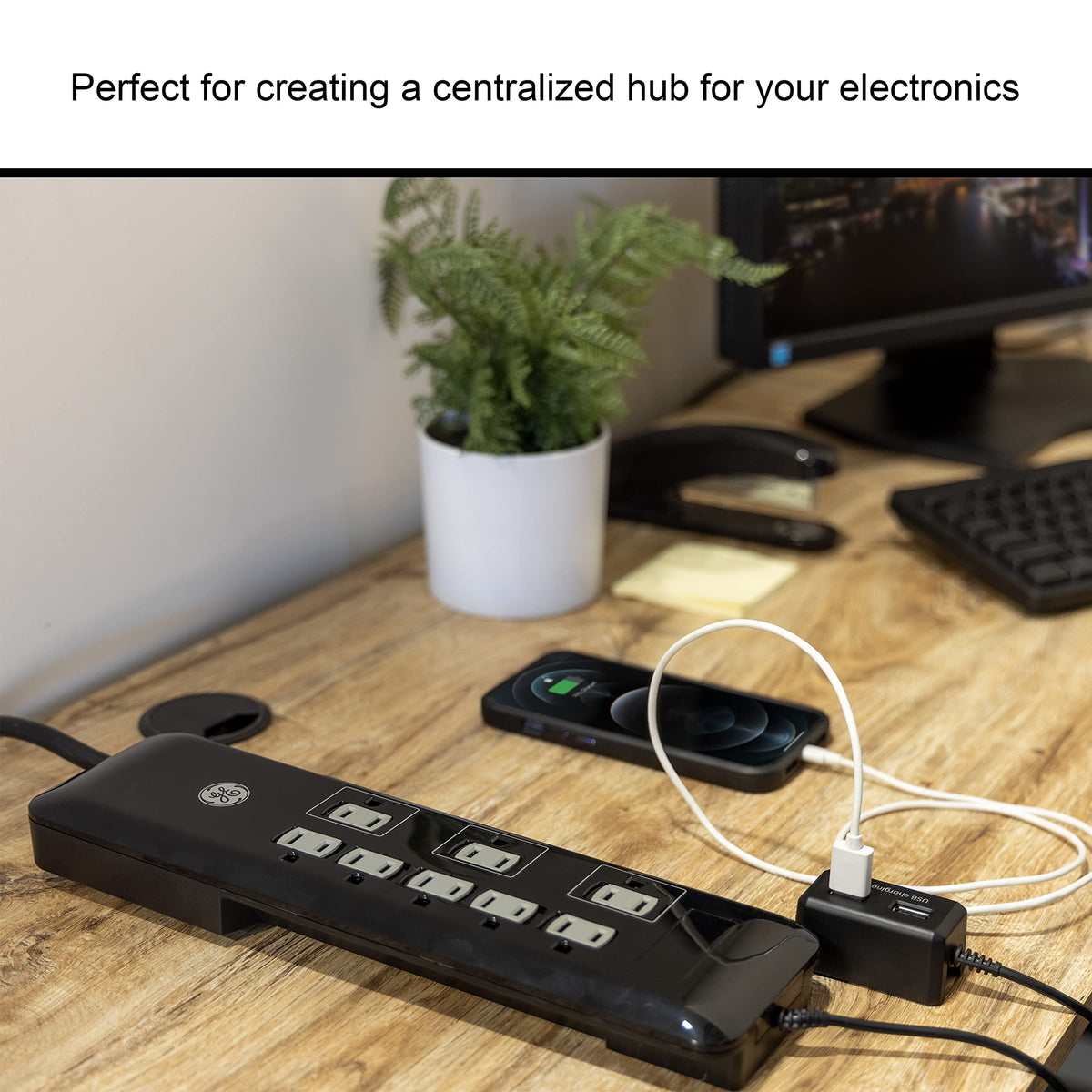 GE UltraPro powering TV and router in a living room setup for tidy cable management