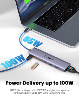 Getatek dock beside notebook for scale to show compact footprint and portability benefit