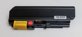 GHU battery beside a ruler for scale demonstrating compact form factor and exact sizing for ThinkPad bays