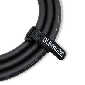 Reusable hook-and-loop wrap keeps cables organized during setup and transport.