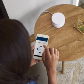 Google WiFi scale with phone showing compact size and simple space-saving benefit