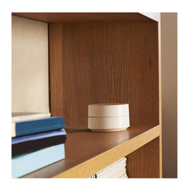 Google WiFi beside a smartphone showing scale and placement benefit