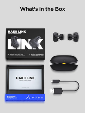 HAKII earbuds beside credit card showing compact scale and portability
