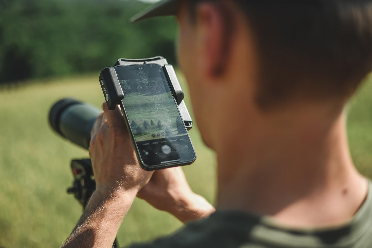 Hawke adapter mounted on a spotting scope capturing distant wildlife easily