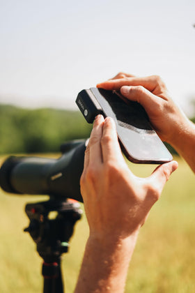 Hawke adapter beside smartphone to show size and portability for field use