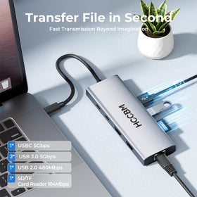 HCCBM dock connected on desk with laptop and accessories for organized workstation