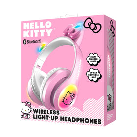 Hello Kitty folded headphones next to a backpack showing compact portability