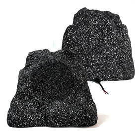 Herdio garden-blend rock speaker tucked among greenery for rich outdoor audio