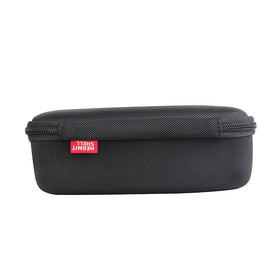 Compact travel case beside a backpack for outdoor trips.