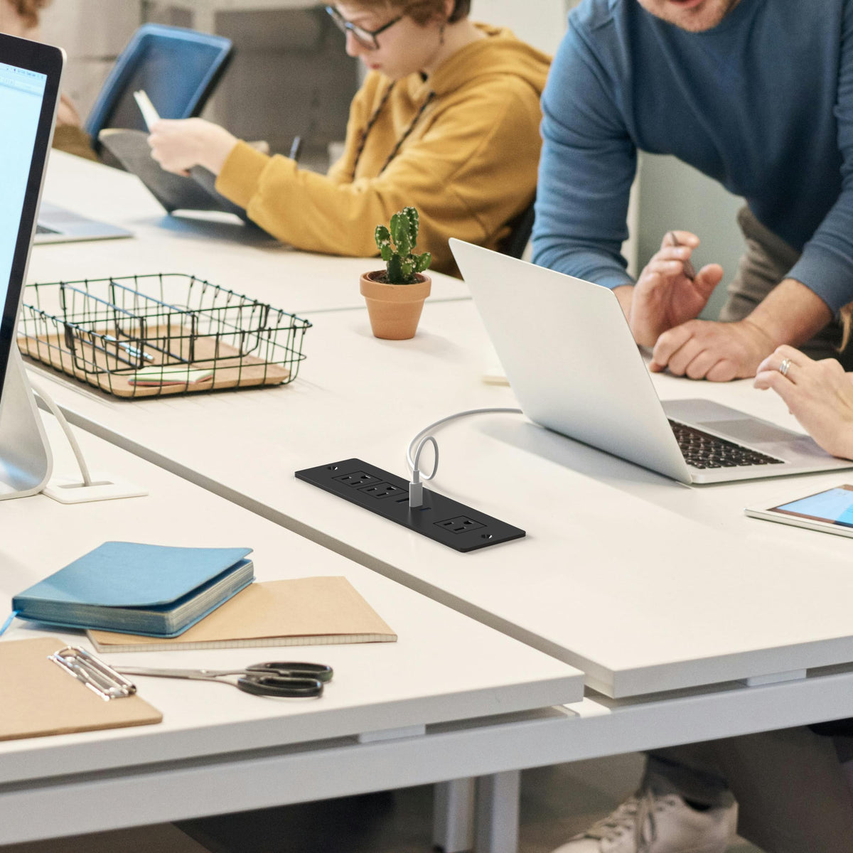 HEZI lifestyle shot in home office showing concealed power and neat device charging