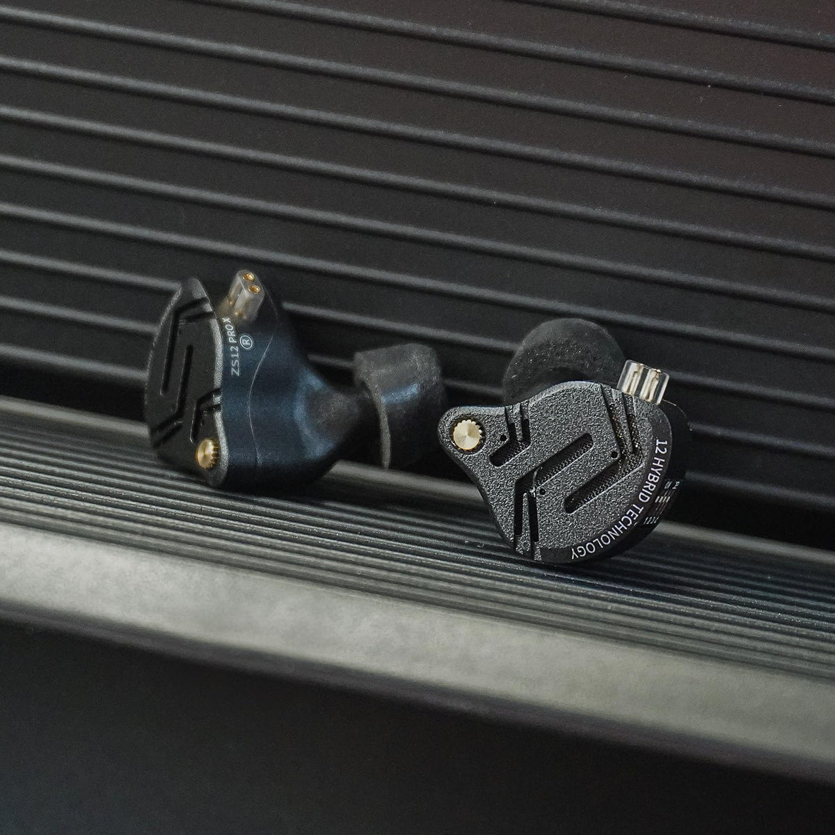 H HIFIHEAR KZ ZS12 PRO X size comparison with a coin showing compact form for portable use