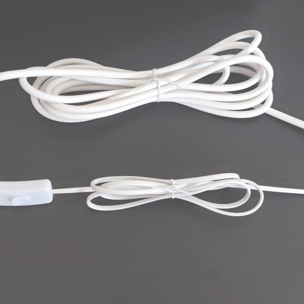 HHTHH white cable ties in garden setting for plant support and organization.