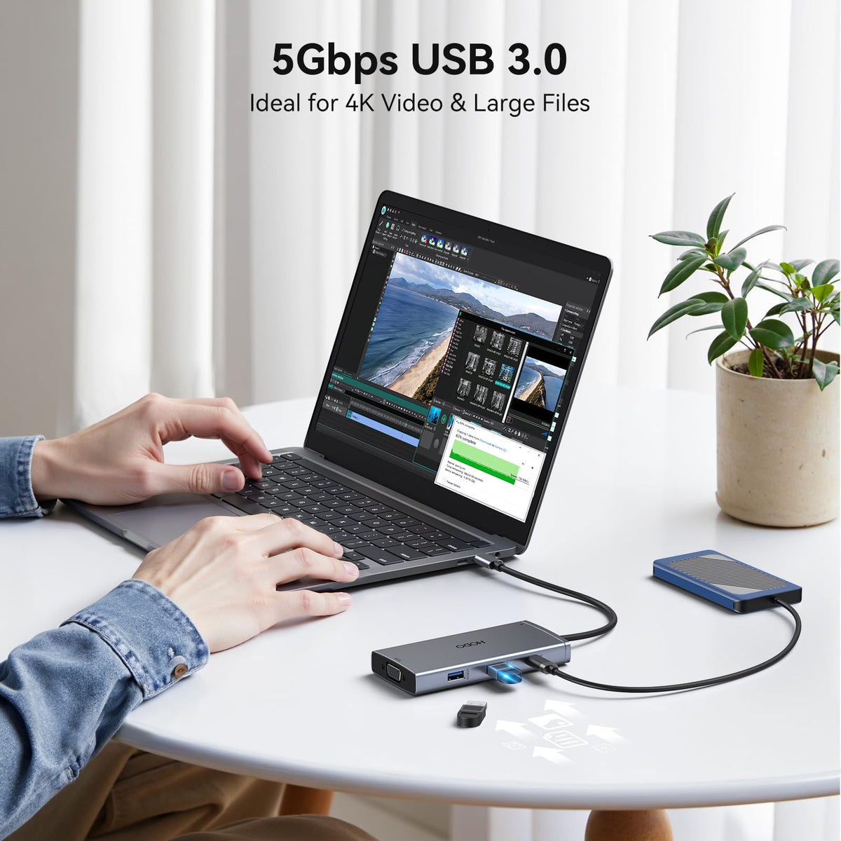 HODO docking station size comparison next to laptop to show compact portable footprint