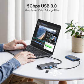 HODO docking station size comparison next to laptop to show compact portable footprint