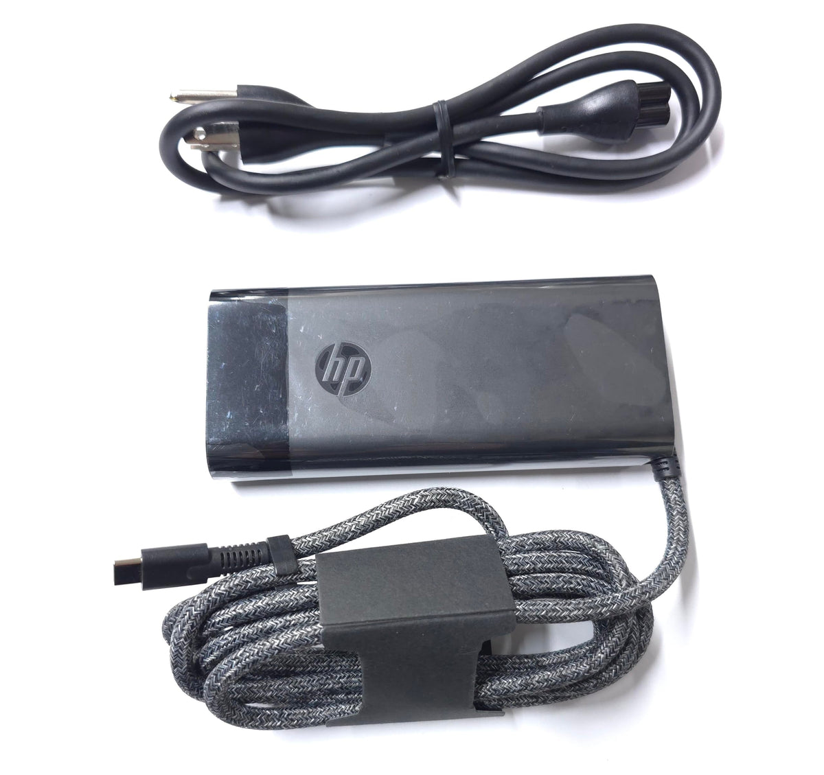 HP 100W USB-C Charger cable neatly wrapped for portable use.