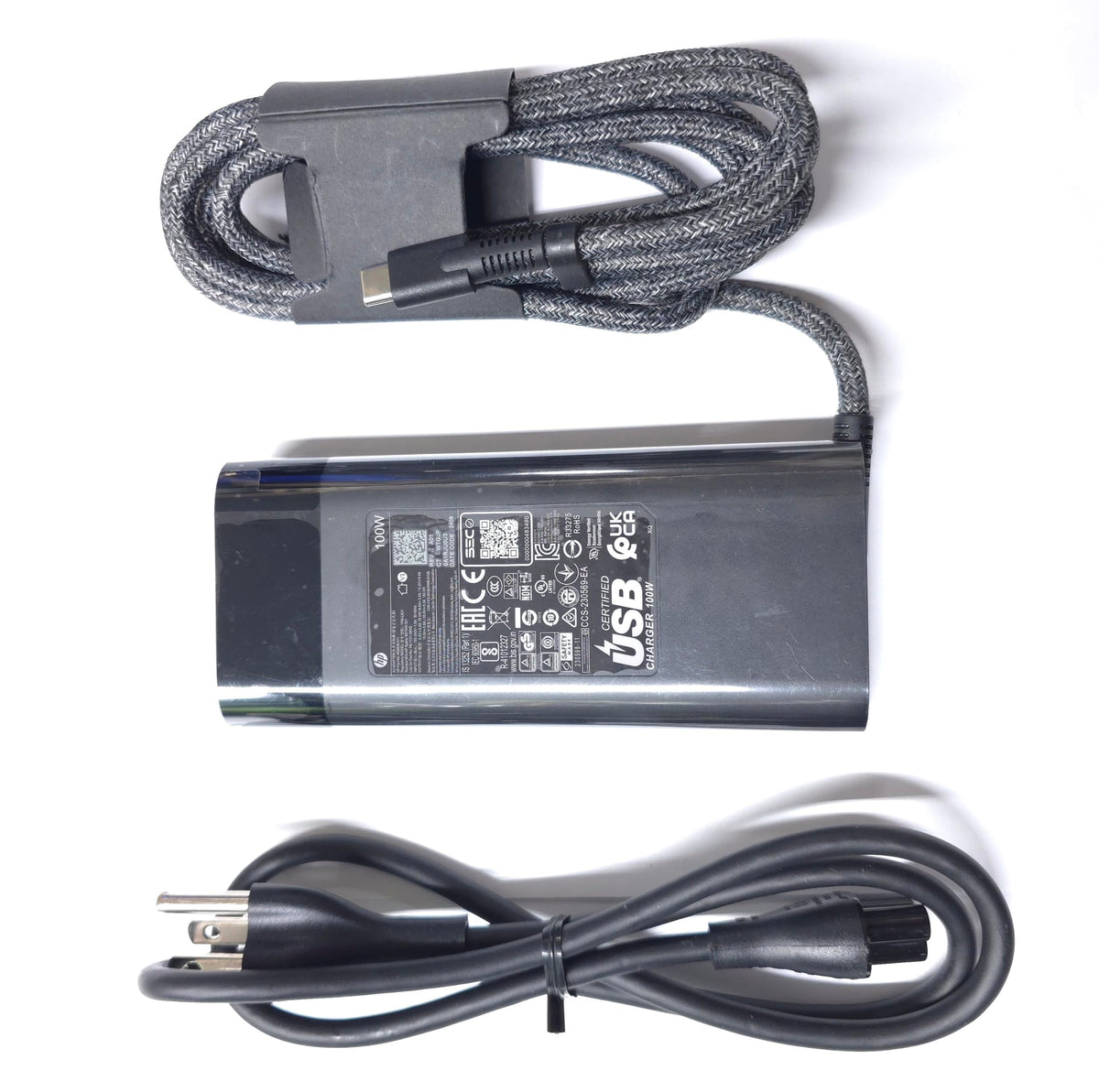 HP 100W USB-C Charger P/N label helps verify compatibility.