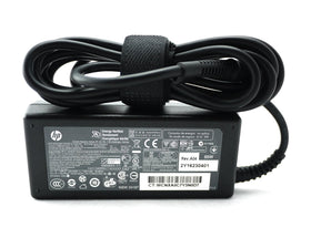 HP 65W adapter front view showing compact design and labeling for safe charging