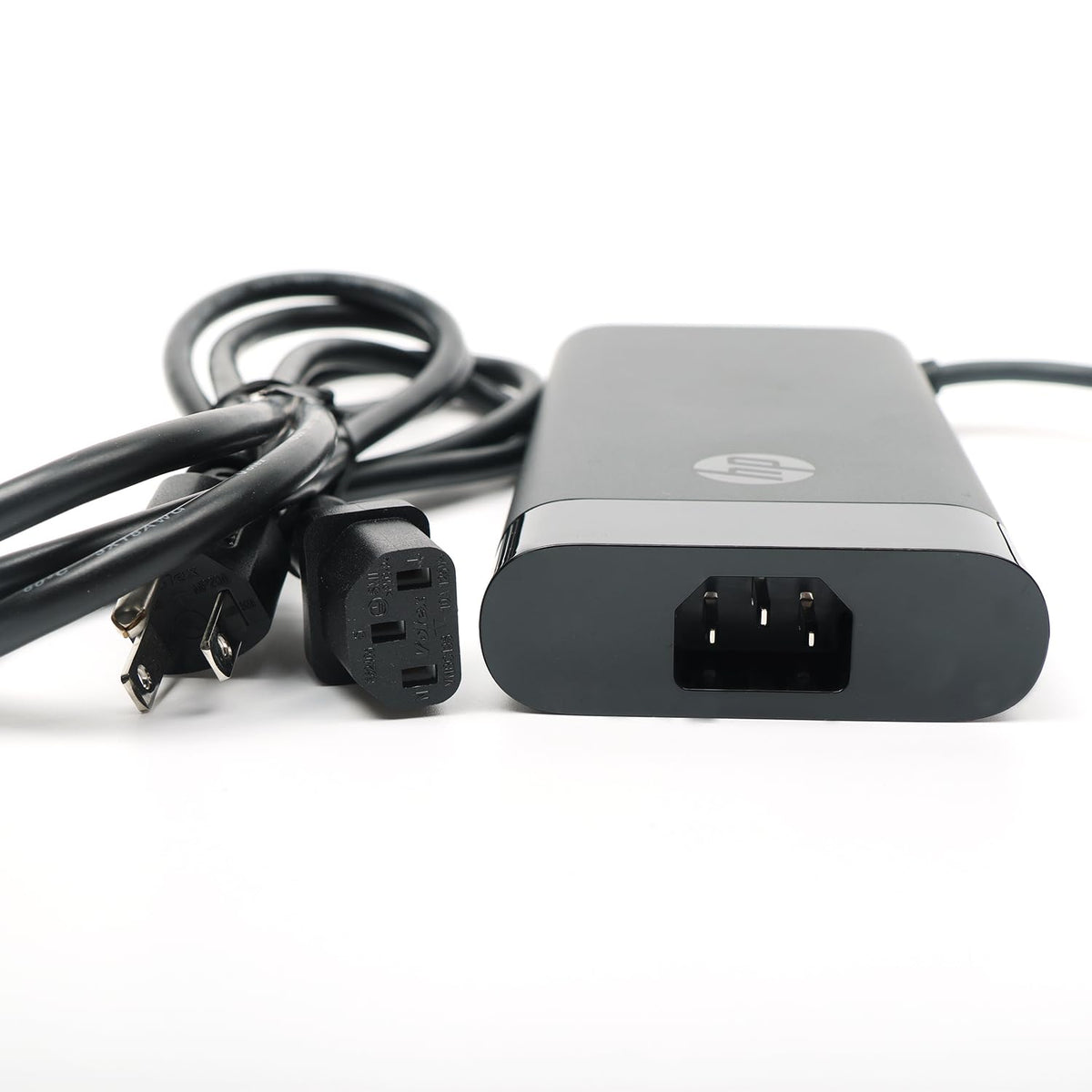 HP adapter on desk with laptop for a tidy, dependable workstation