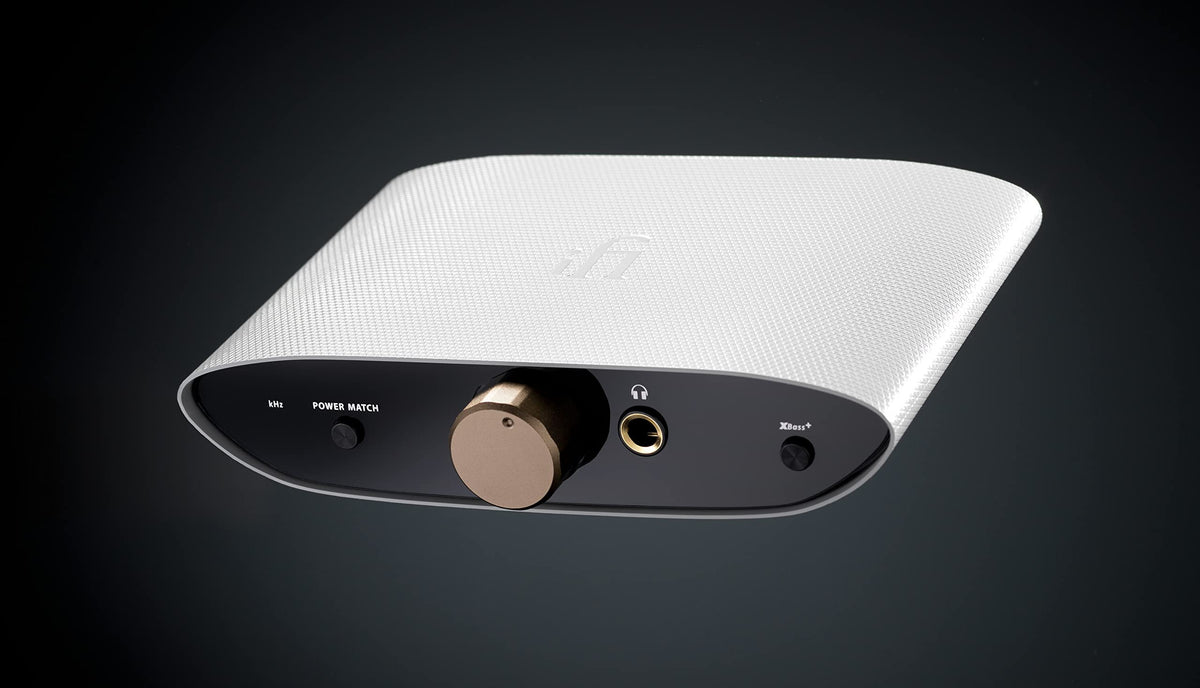 iFi Zen Air DAC in use on a desk with headphones for improved audio quality
