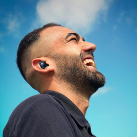 iJoy earbuds used during gym workout showing sweatproof durable design