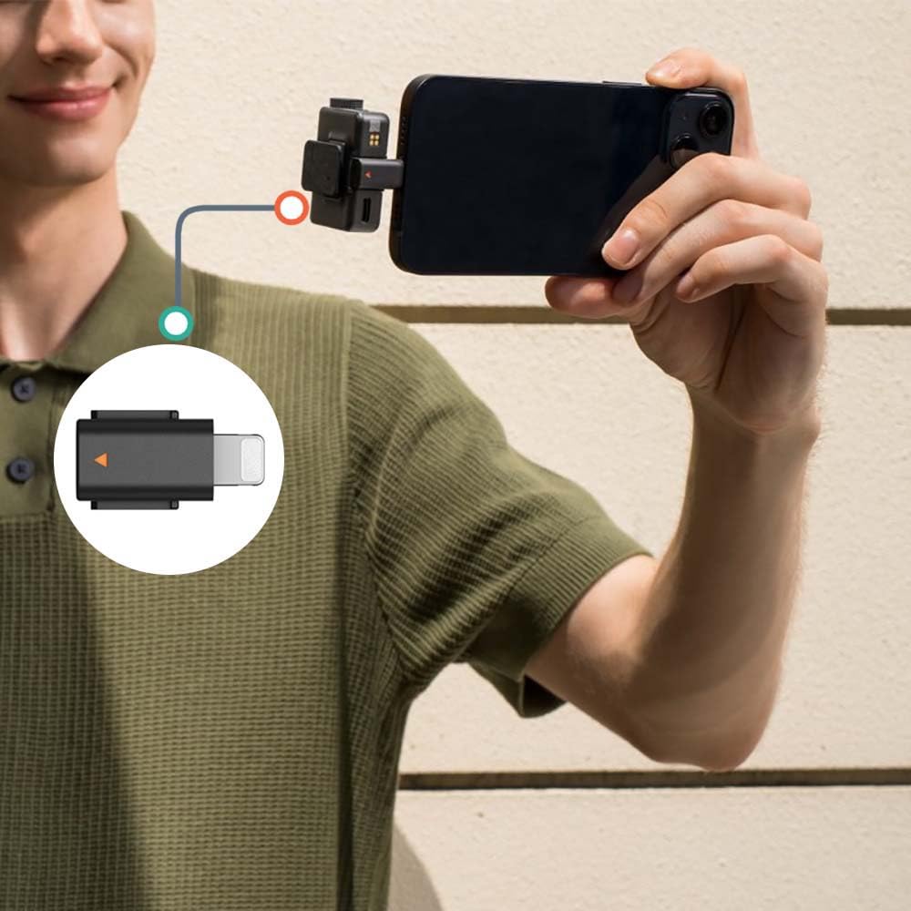 iMusk adapter beside iPhone for scale demonstrating portable convenience