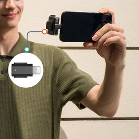 iMusk adapter beside iPhone for scale demonstrating portable convenience