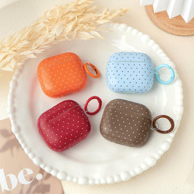 inewateri AirPods 4 case closeup shows polka dot texture and grip.