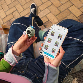 instax in hand demonstrating pocketable size and travel convenience