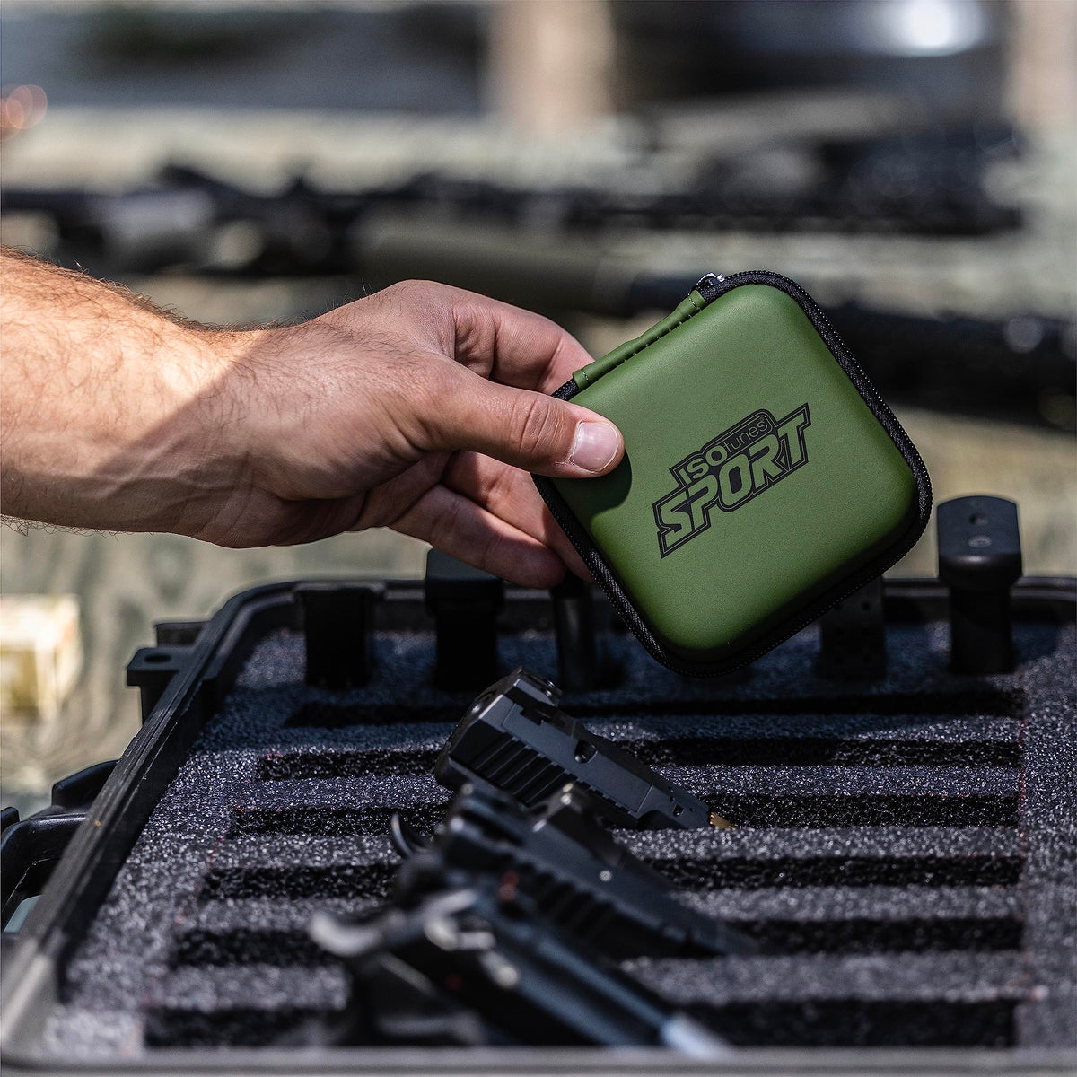 ISOtunes Sport Advance BT earbuds in OD green for outdoor shooting.