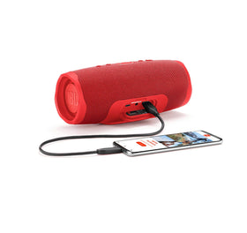 Dual bass radiators of the red Charge 4 deliver punchy, immersive sound at a party
