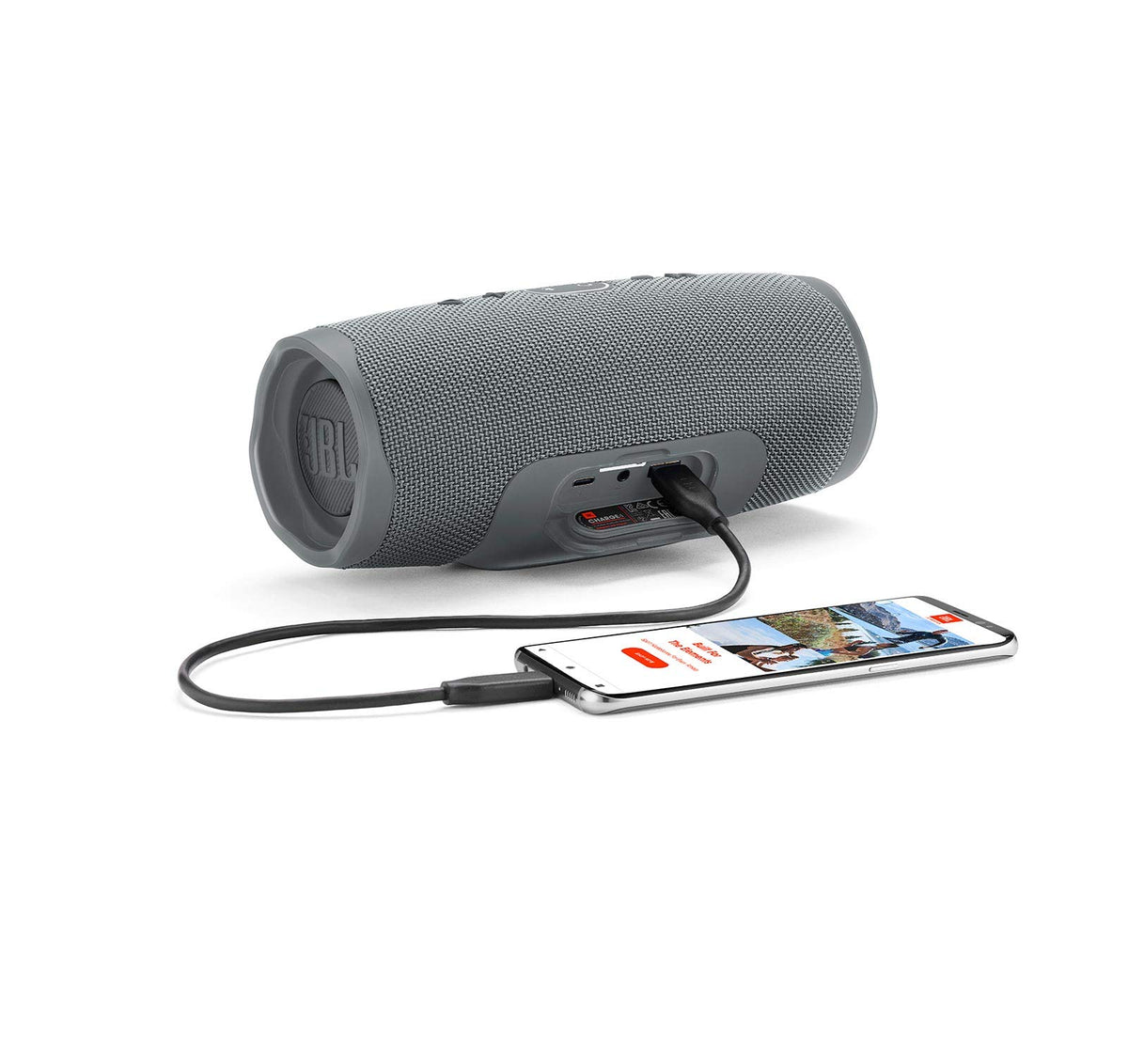 JBL Charge 4 waterproof IPX7 in beach setting for splashes and immersion.