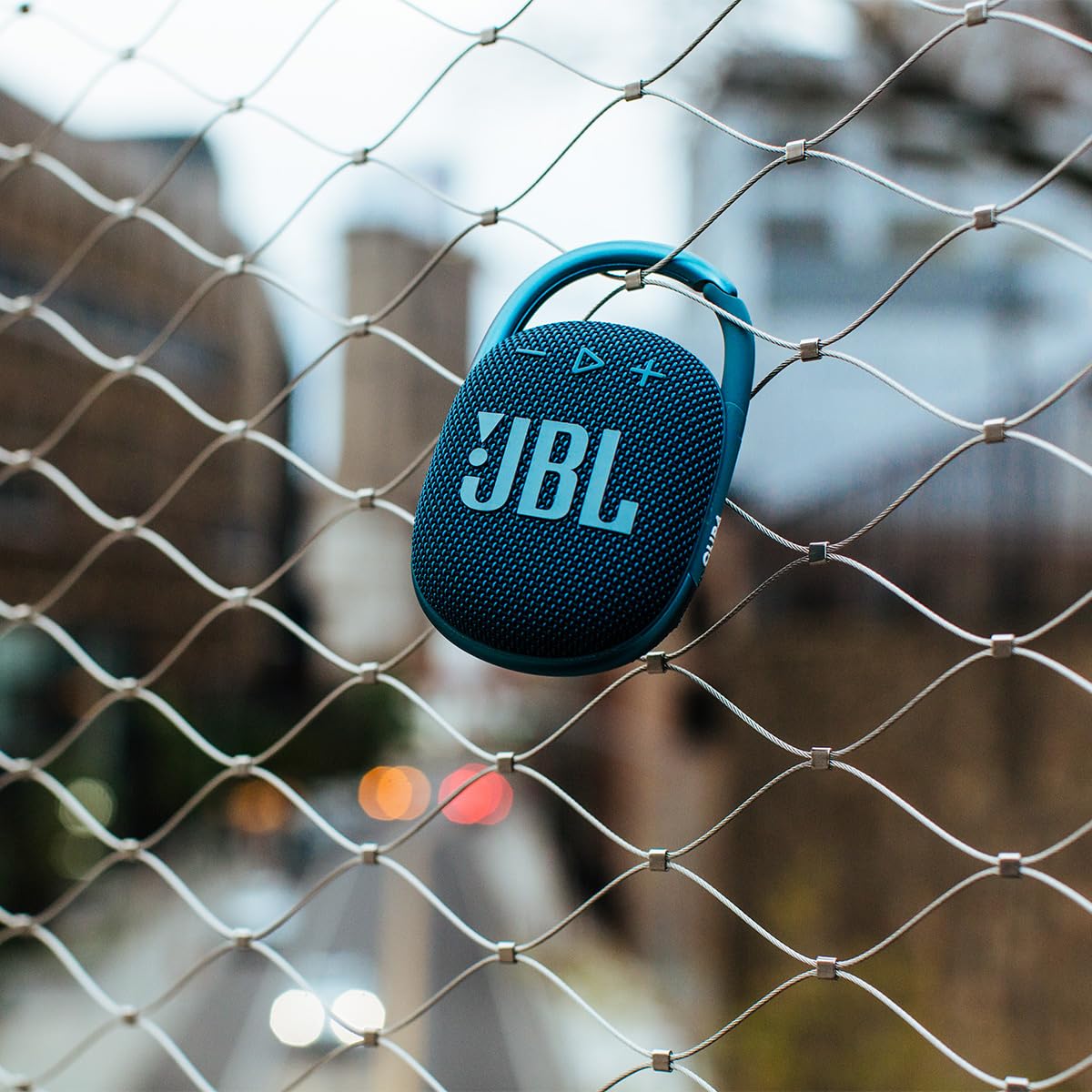 JBL Clip 4 side view with integrated carabiner for easy attachment to bags.