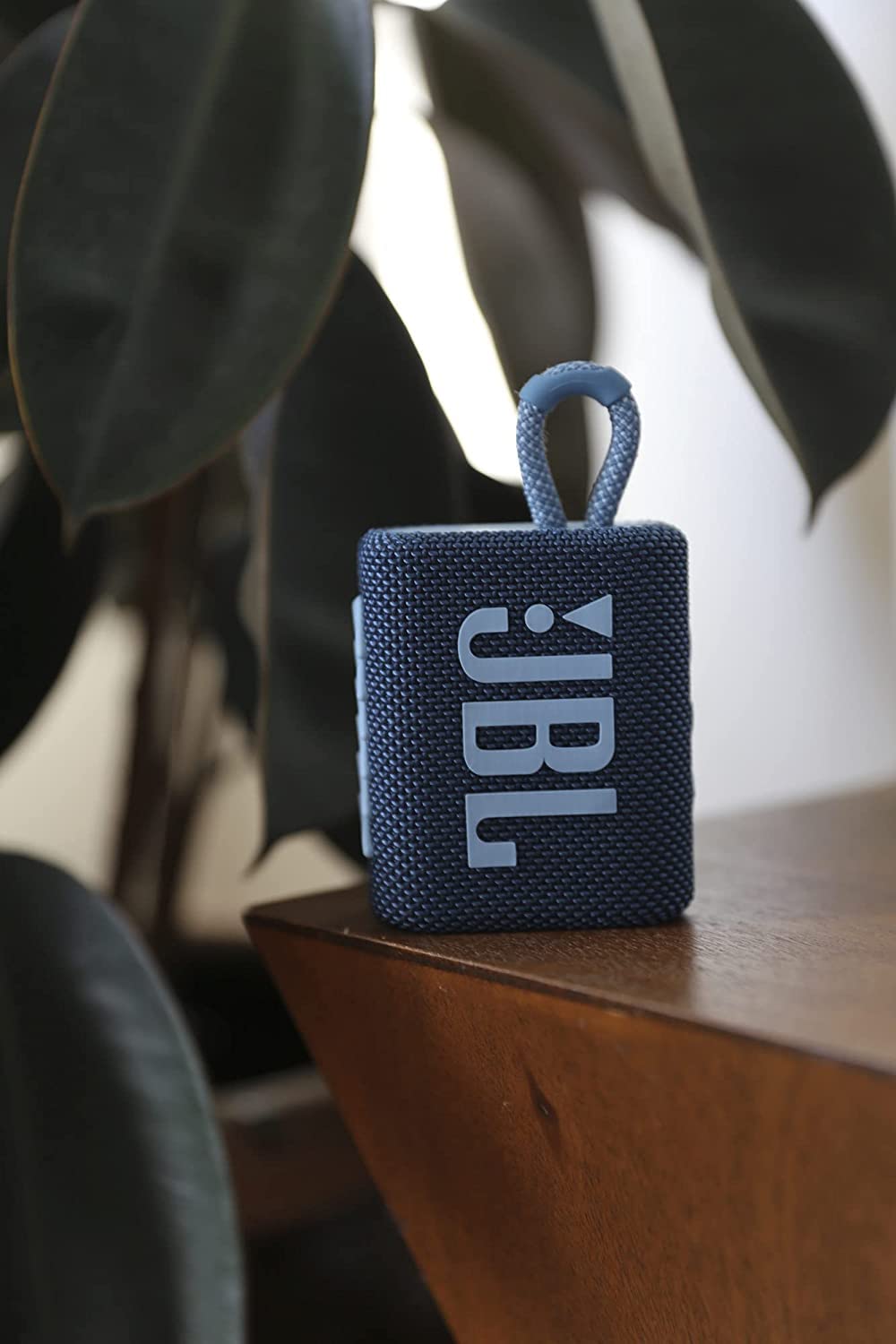 JBL Go 3 poolside on towel demonstrating waterproof protection for outdoor use