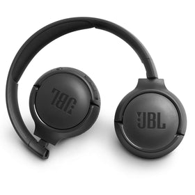 JBL Tune 500BT next to hand to show scale and lightweight benefit