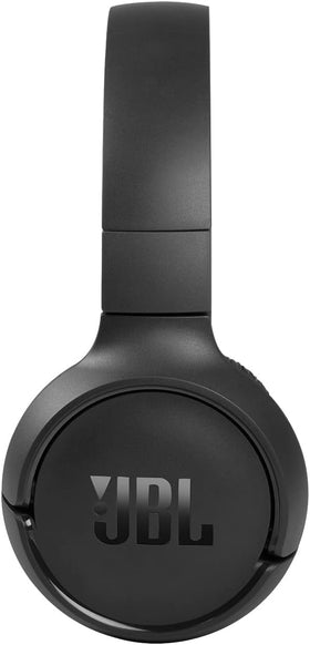 Person wearing JBL Tune 510BT during commute showing secure fit and hands-free calling