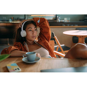 Person wearing JBL Tune 520BT on commute showing comfortable everyday use