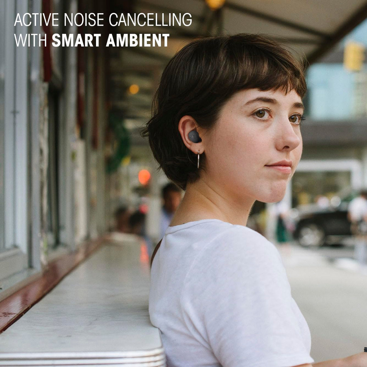 Hand holding JBL Vibe Buds 2 to show scale, emphasizing pocketable convenience