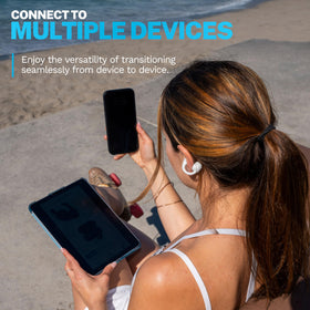 JLab Flex next to a smartphone for scale, showing compact case and portability benefits