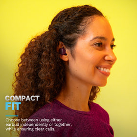 JLab earbuds on a runner outdoors, illustrating stable fit and on-the-go use