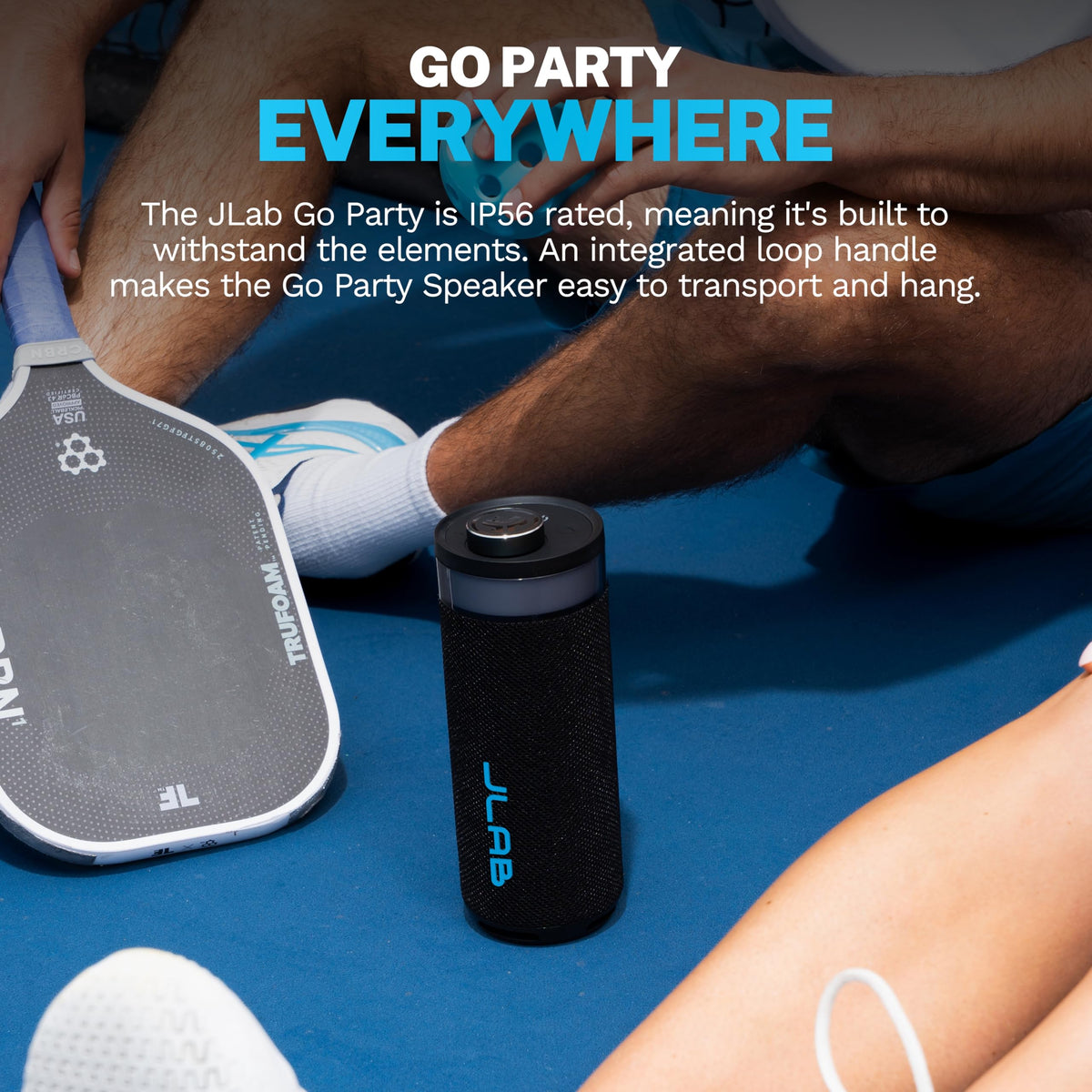JLab Go Party in hand to show compact size and travel-friendly scale