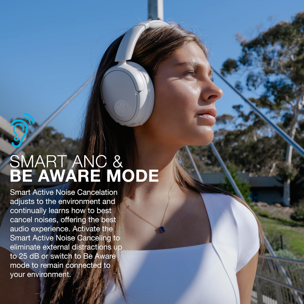 JLab folded headphones next to phone showing compact travel scale