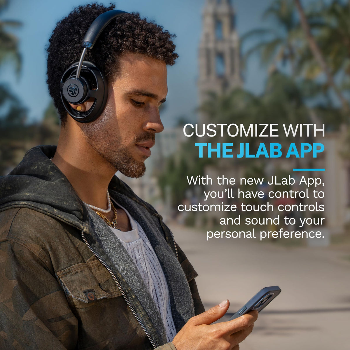 JLab JBuds Open paired with phone and laptop on screen showing multipoint convenience benefit