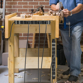 JUNNUJ installed on a garage workbench powering tools and keeping workspace organized