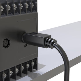 JUXINICE cable attached to a PLC touchscreen demonstrating control-link reliability