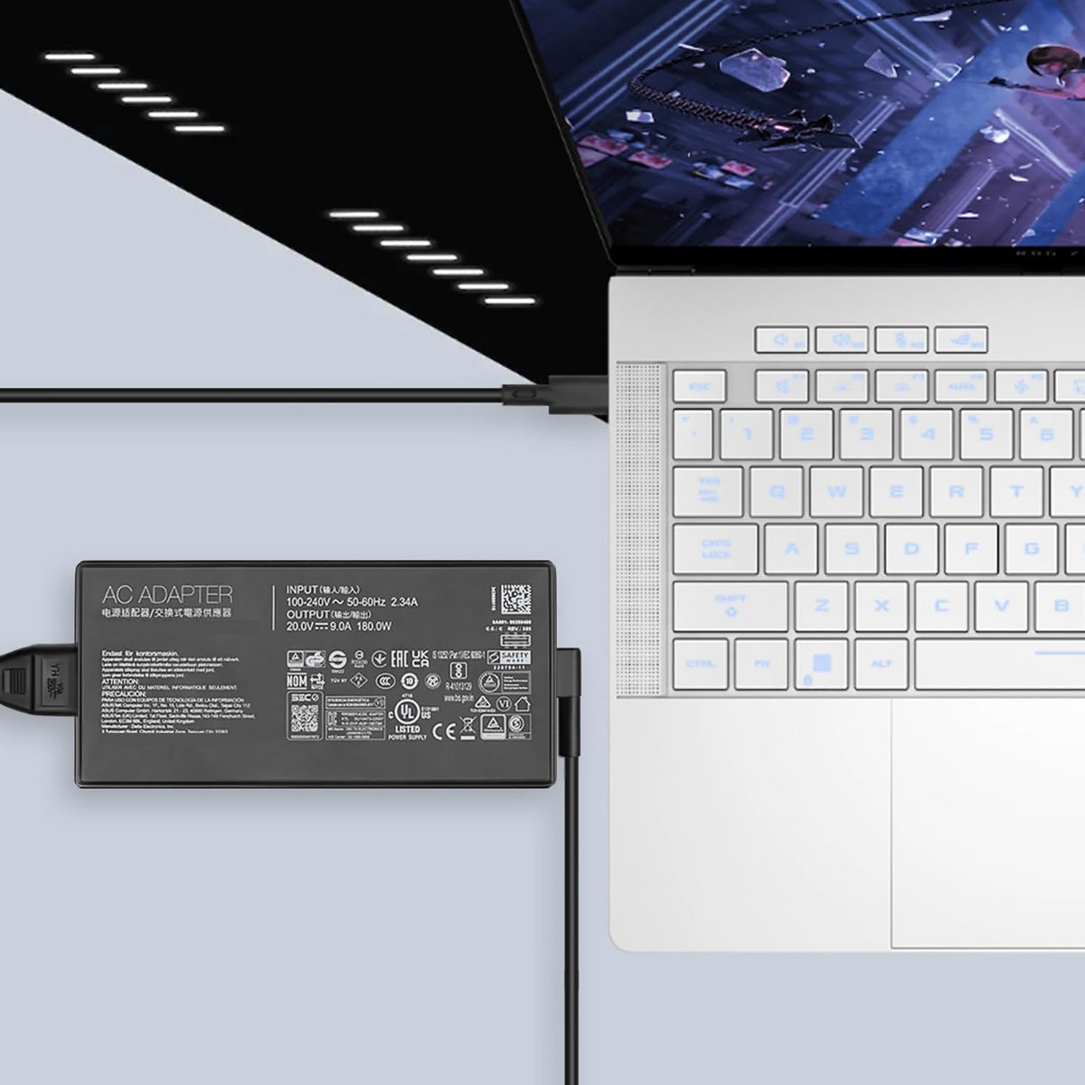 JUYOON size comparison beside a laptop charger showing compact, portable design