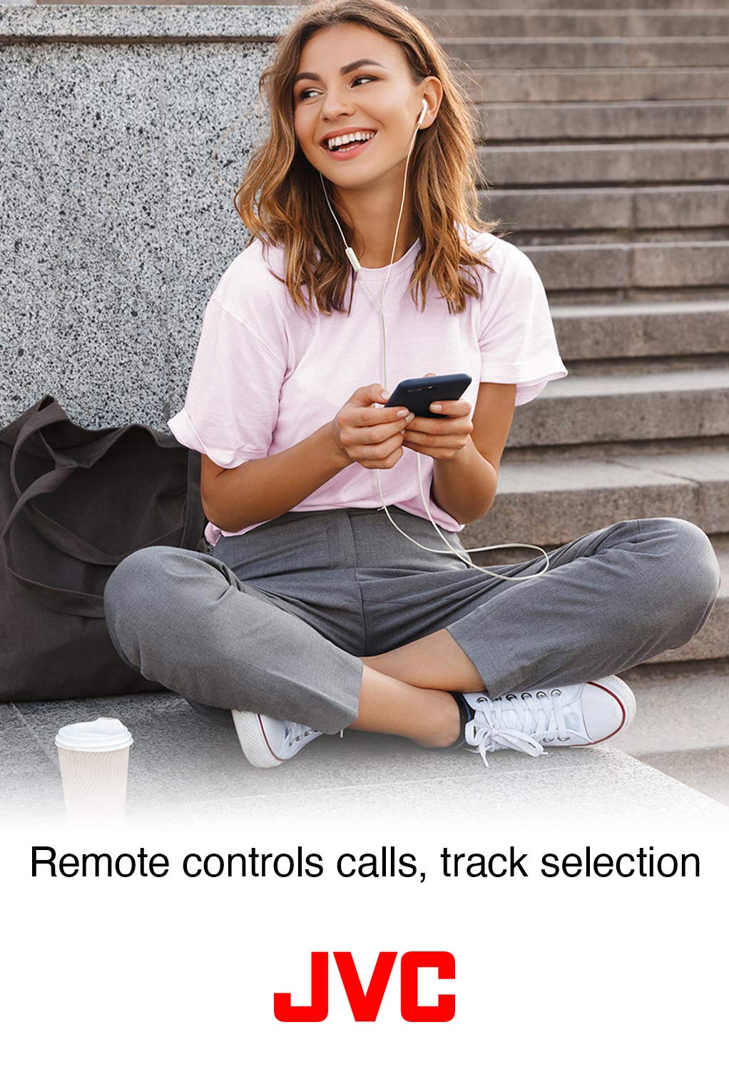 JVC earbuds draped over a backpack to show the 3.28 ft cord reach and portability