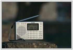 Kaito TECSUN PL-380 handheld size comparison showing pocketable portability benefit